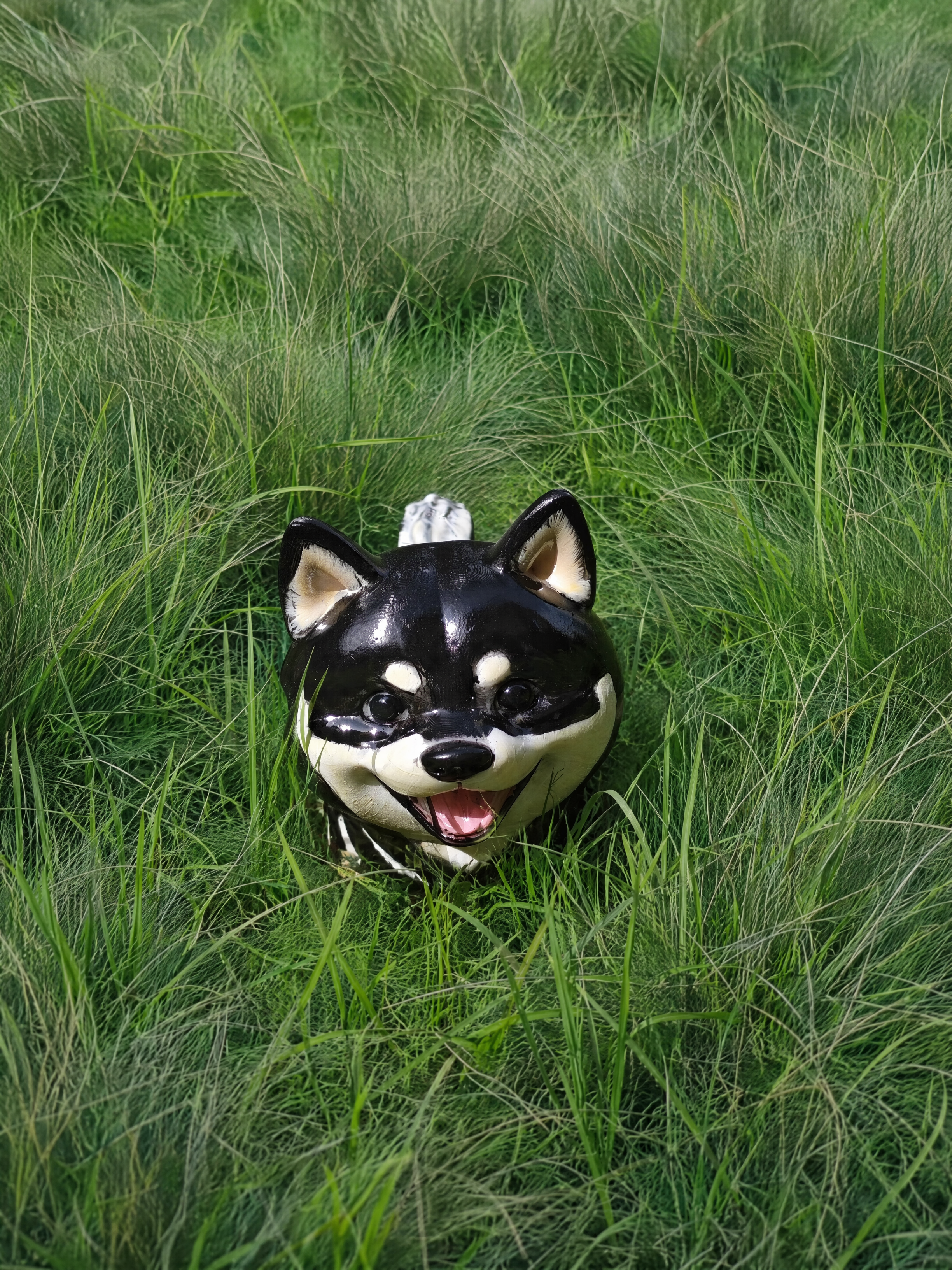 Custom dog figurine made from a photo — black Shiba Inu standing in tall grass, front view