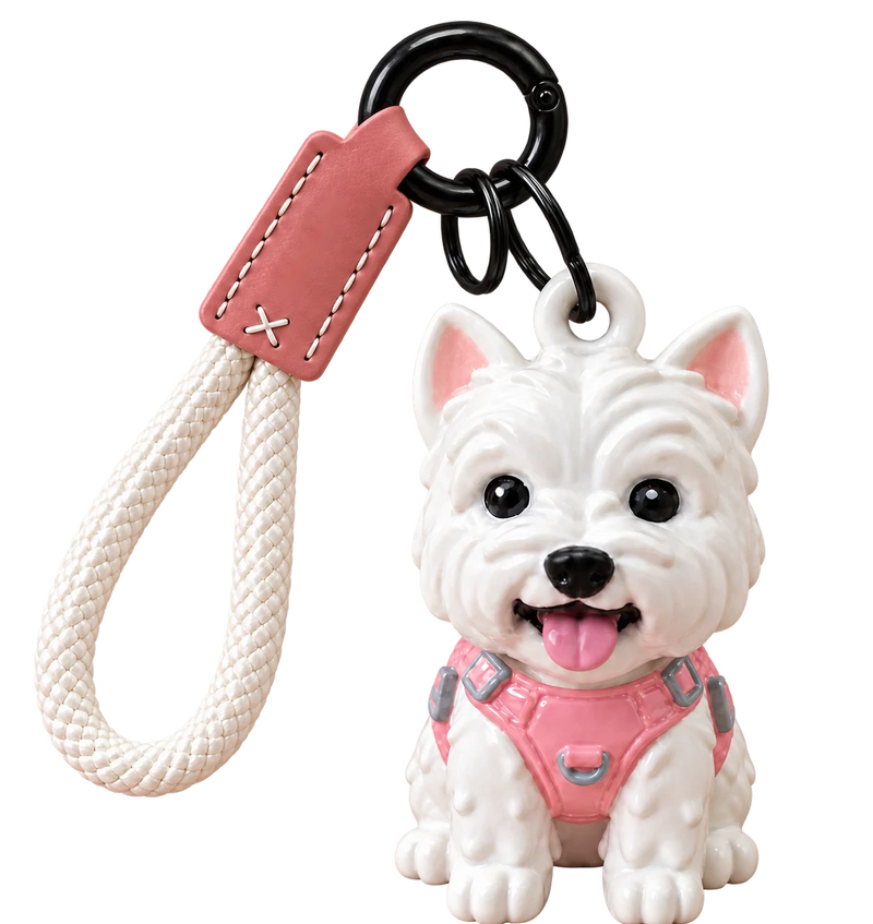 White Westie resin keychain in a pink harness, with ivory braided wrist loop, stitched pink leather tab and round black ring